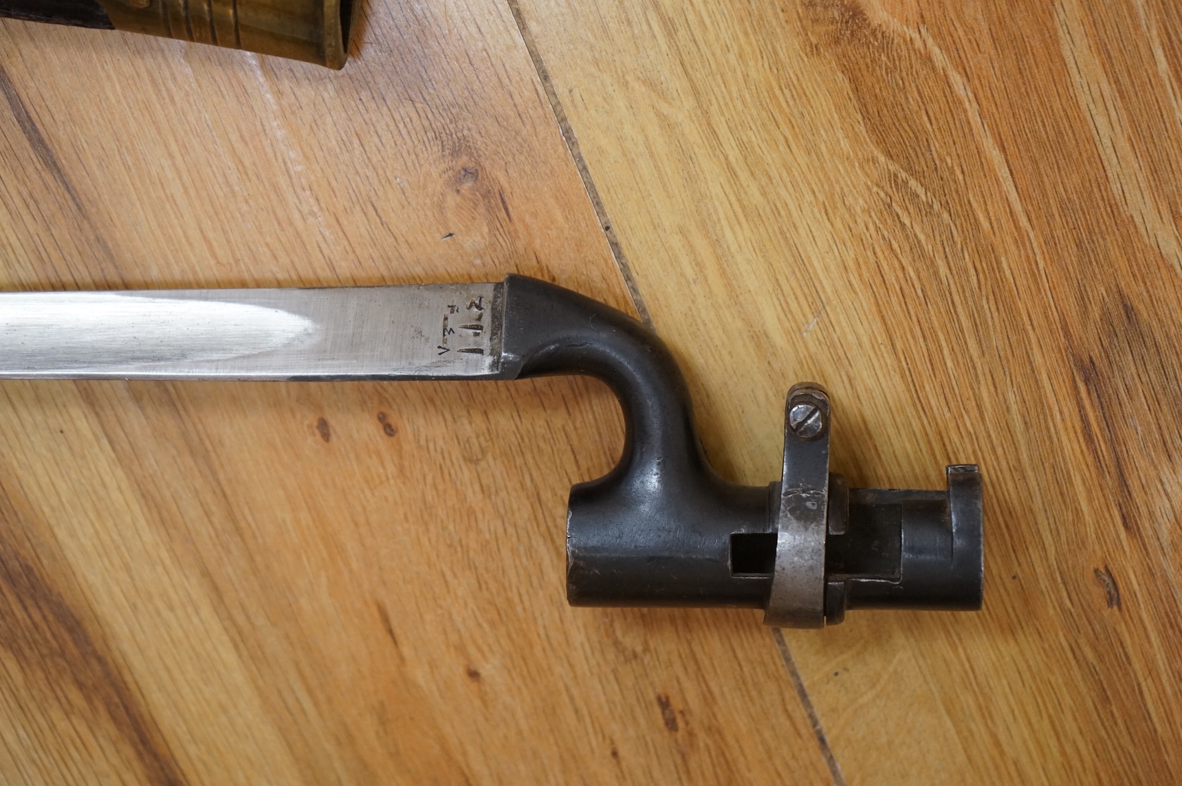 Three bayonets; a gras bayonet, a Lebel bayonet and an Indian Enfield style triangular socket bayonet, all in the original scabbards